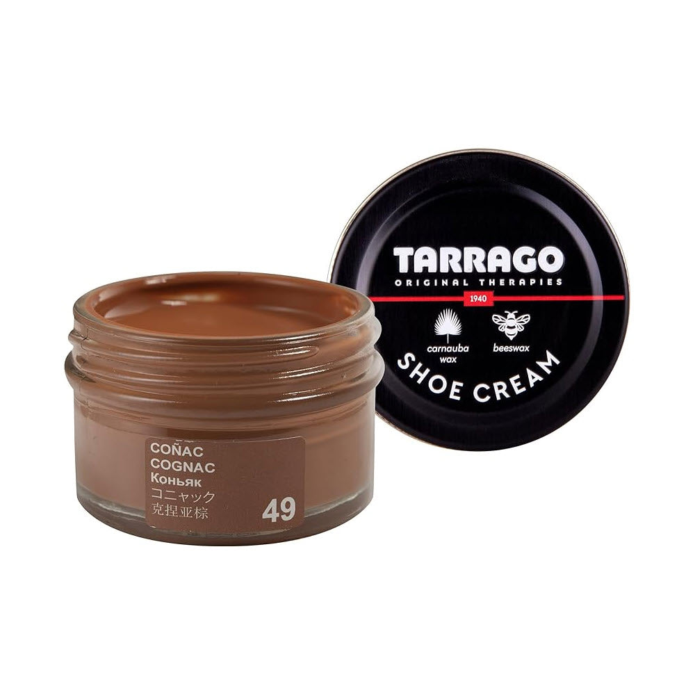 A jar of F.L. Inc Tarrago shoe cream in &quot;cognac&quot; color with an open black lid featuring the brand logo and ingredients.