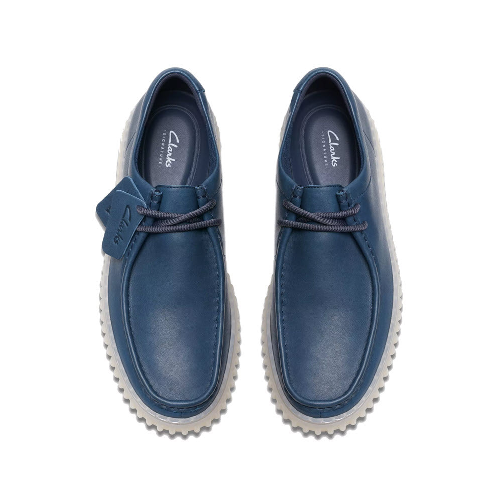 A pair of Clarks Torhill Lo Lace Leather Oxford Navy shoes with ribbed outsoles, viewed from above on a white background.