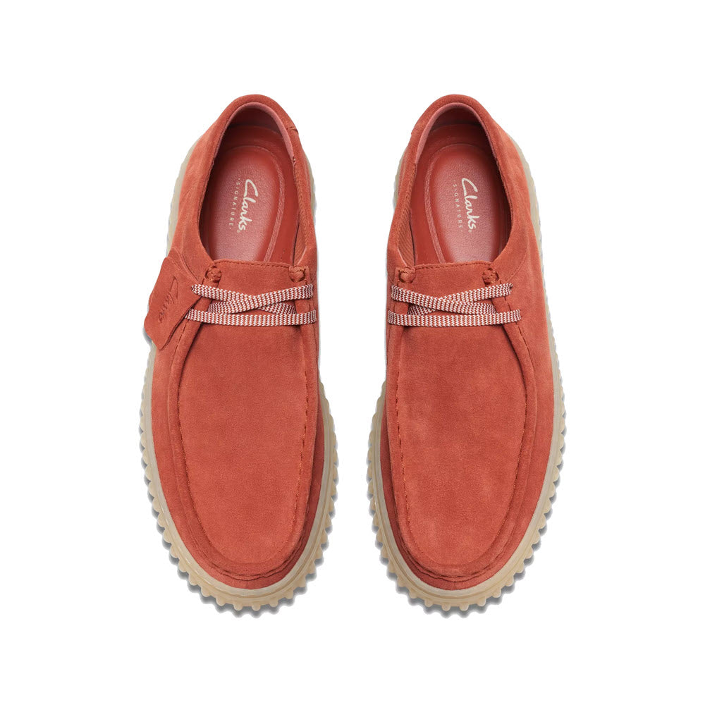 A pair of red suede Clarks Torhill Lo Lace Leather Oxford Rust shoes with a flat, light-colored sole, viewed from the top on a white background.