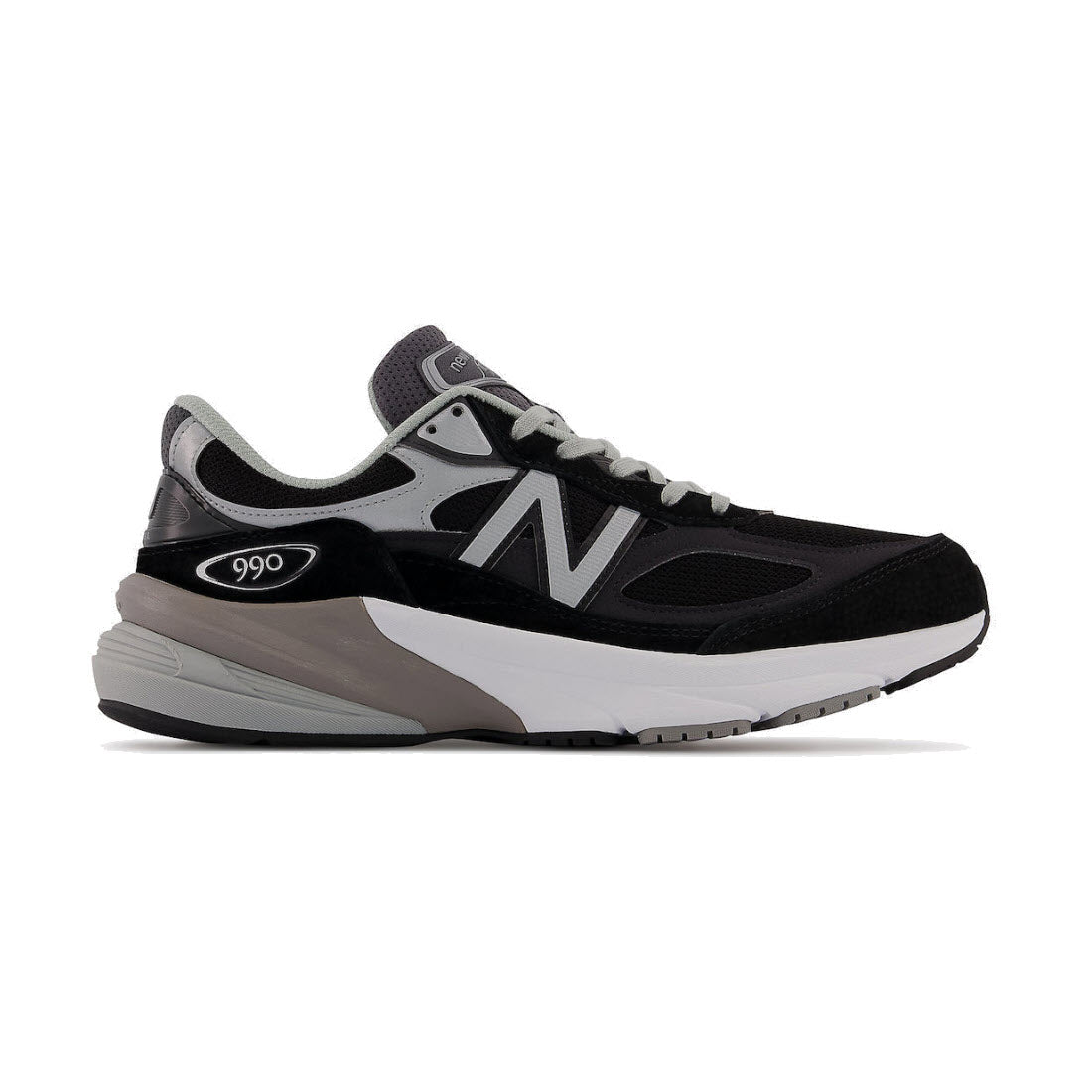 A New Balance 990v6 sneaker in black and gray, showing a side profile with visible branding.