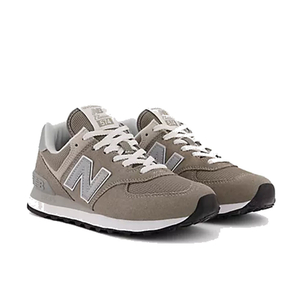 A pair of reliable New Balance 574 classic sneakers in gray with white and black detailing on a white background. 
Product Name: NEW BALANCE 574 GREY - WOMENS
Brand Name: New Balance
