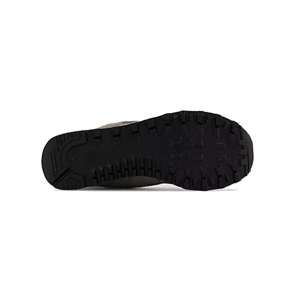 Black rubber sole of a New Balance shoe with textured tread pattern, displayed against a plain white background.