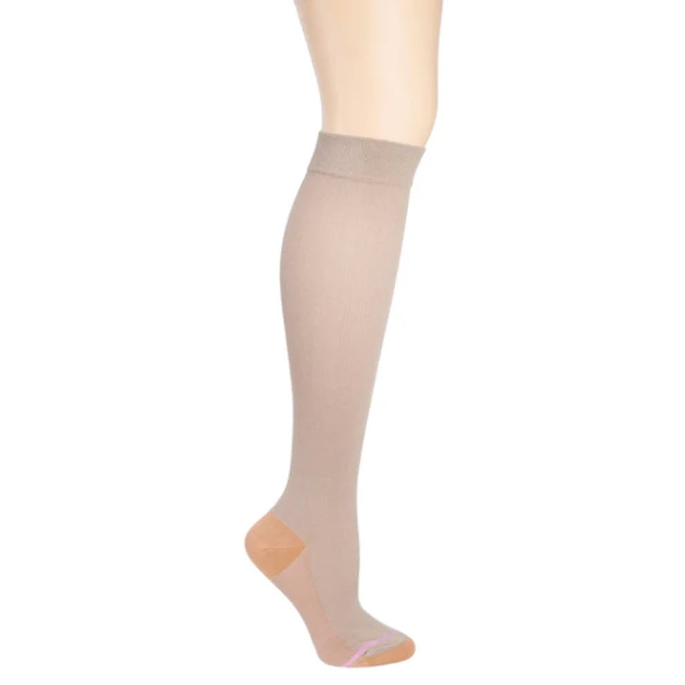 A single Dr Motion beige copper ion infused compression sock worn on a mannequin leg, isolated on a white background.
