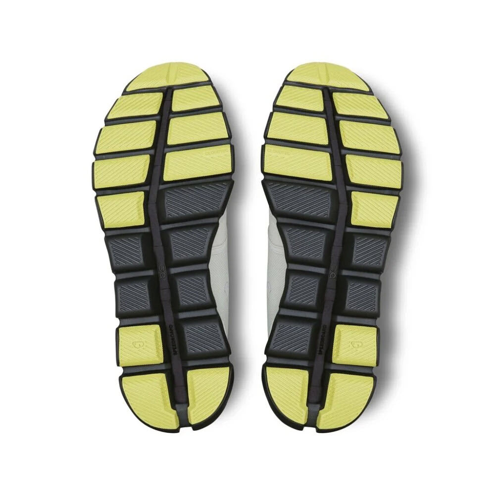 A pair of yellow and black On Running ON CLOUD X 3 ICE/ECLIPSE - MENS shoe soles with CloudTec® cushioning, isolated on a white background.