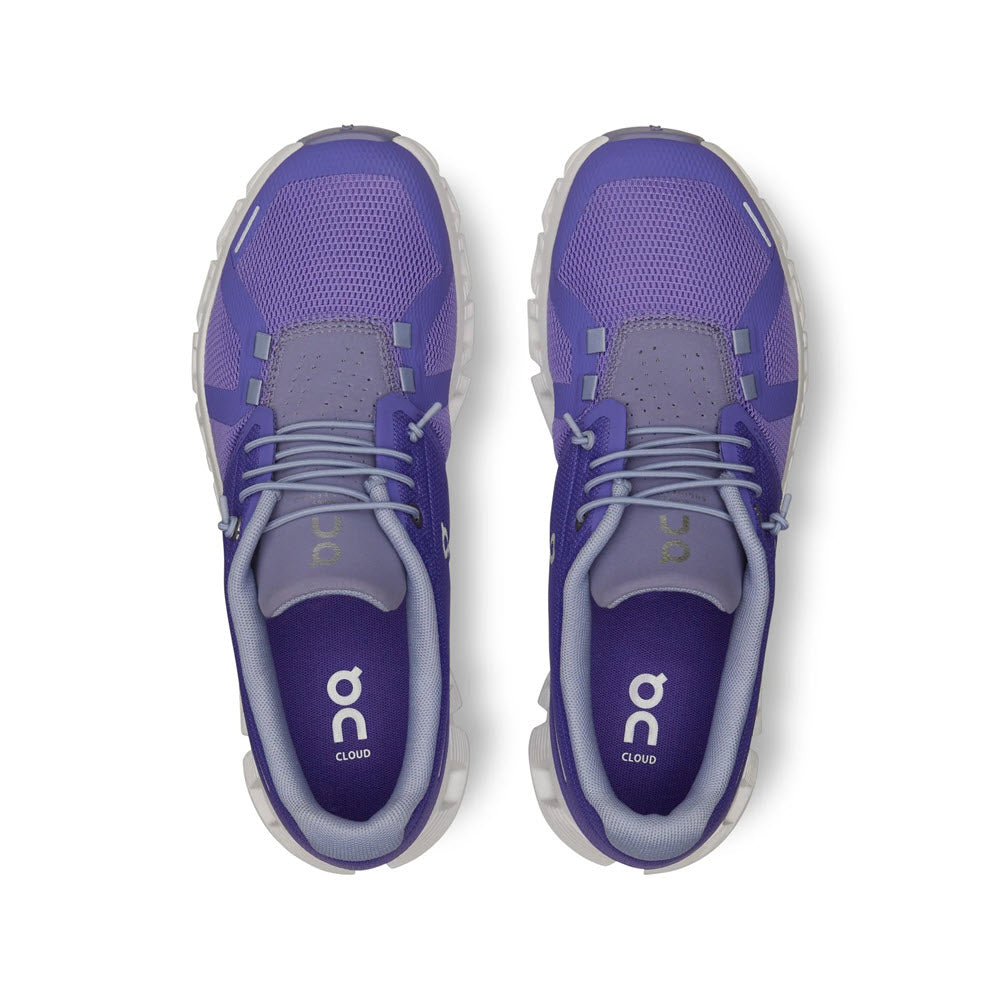 Top-down view of a pair of purple On Running Cloud 5 Blueberry/Feather running shoes with improved fit, on a white background.