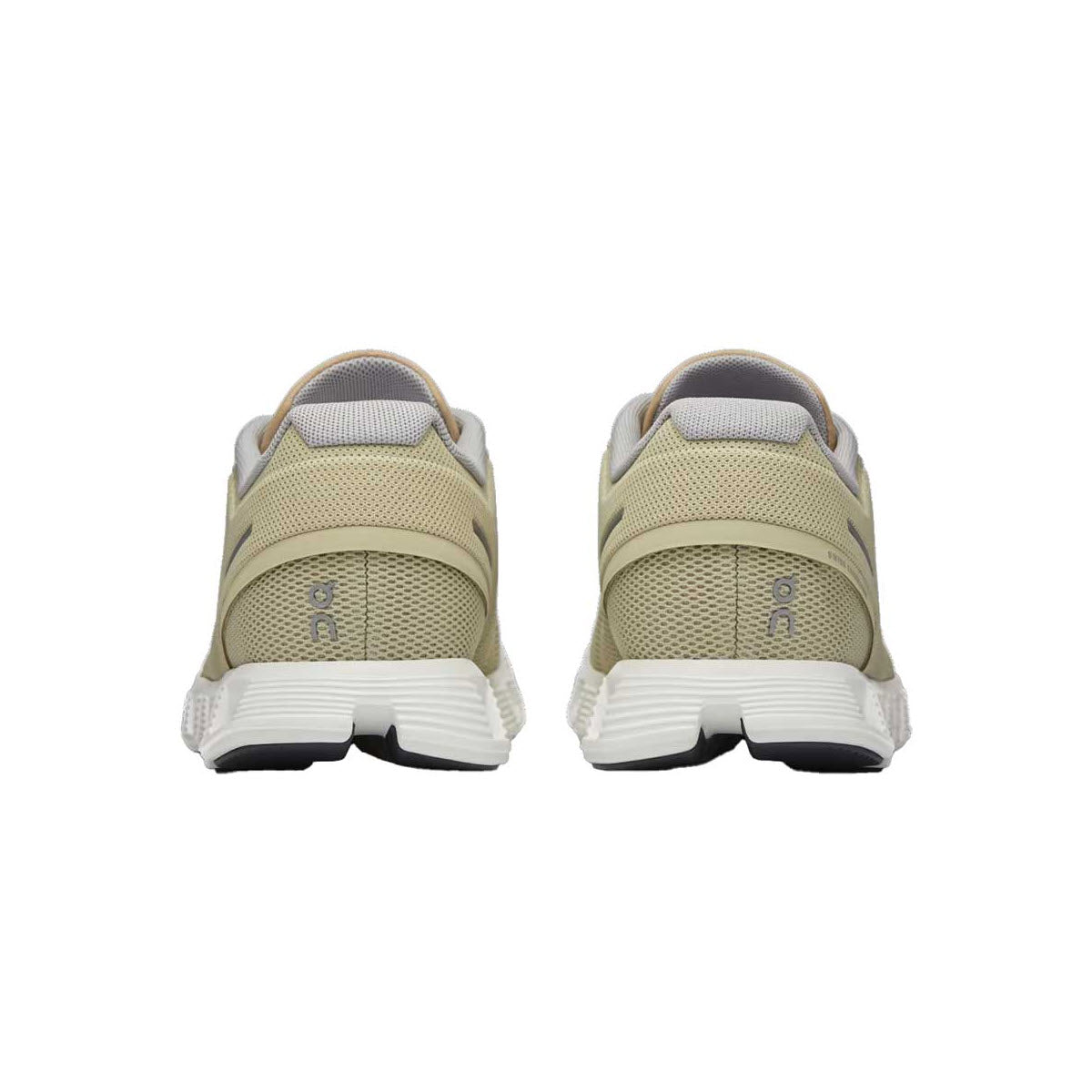 Rear view of a pair of On Running Cloud 5 Haze/Sand - Womens sneakers with white soles and black accents, now featuring an improved fit, displayed against a white background.