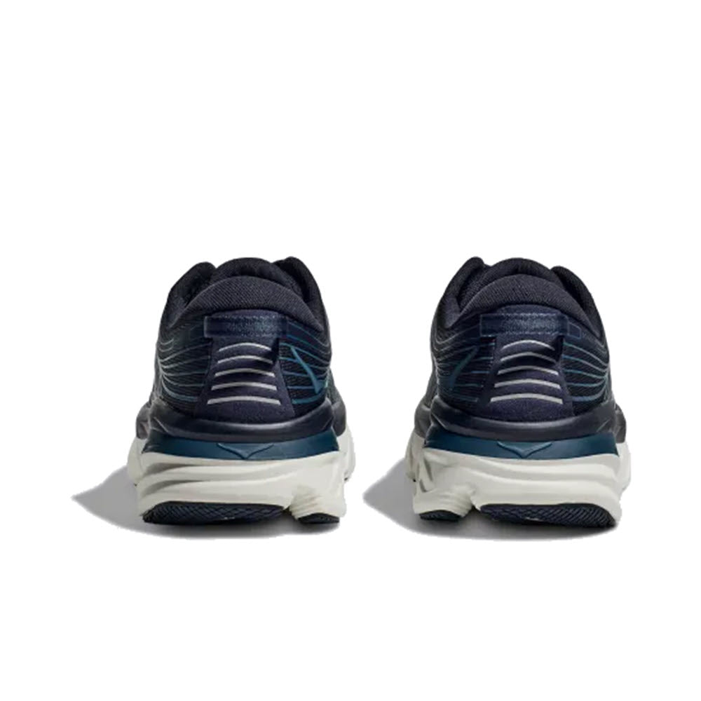 A pair of navy blue HOKA Bondi 7 OUTERSPACE/WHITE - MENS running shoes with teal accents, viewed from the back on a white background.