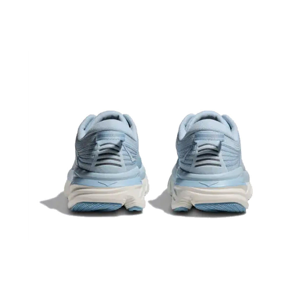 Rear view of a pair of cushioned light blue HOKA BONDI 7 Ice Water/White - Womens sneakers on a white background.