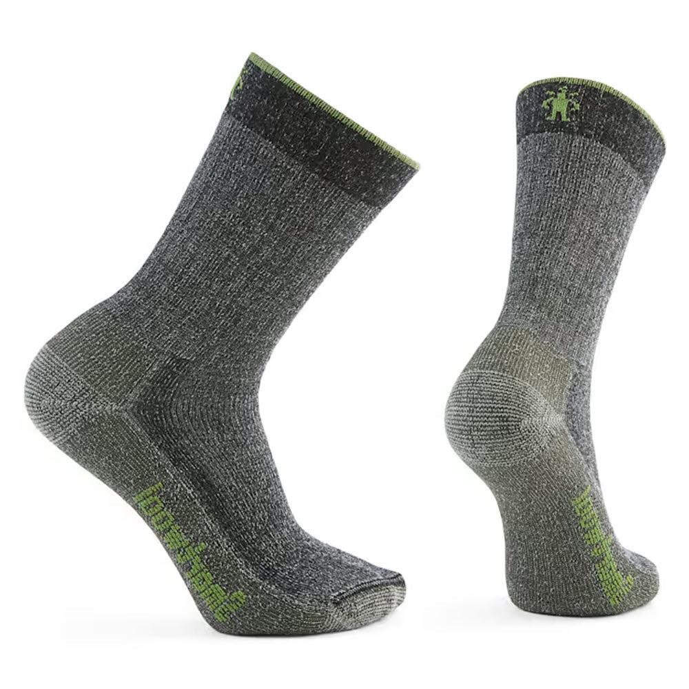 Two black Smartwool Hike 2nd Cut Crew Socks for men, featuring a green logo and trim. Made from recycled Merino wool fibers, the left sock is slightly tilted while the right stands upright, showcasing different angles. Ideal for comfort and sustainability on adventures.