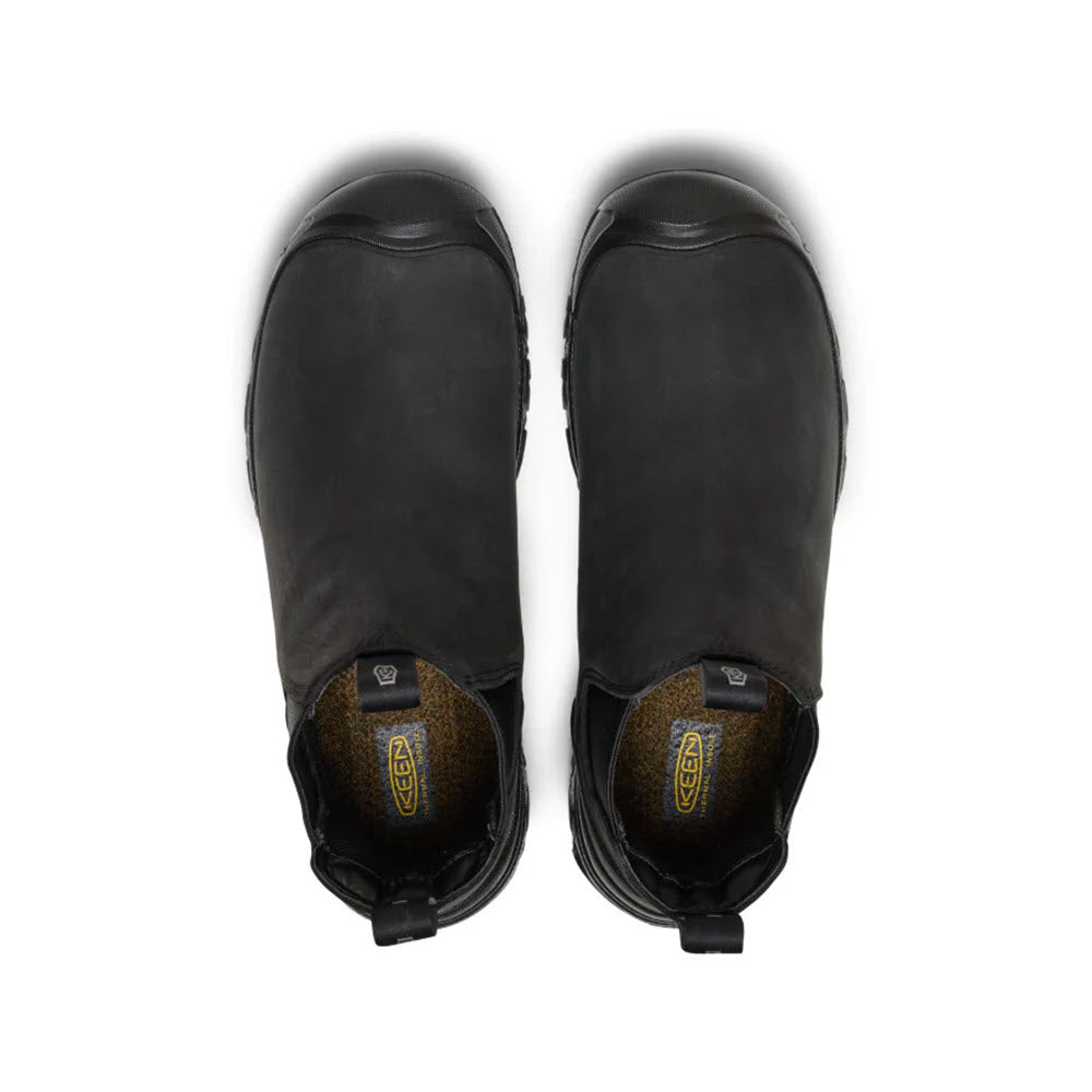 Top view of the KEEN ANCHORAGE CHELSEA BOOT WATERPROOF INSULATED BLACK for men by Keen, featuring durable black leather, rubber toe caps, pull tabs at the back, and brown interiors with a yellow and black pattern on a white background.