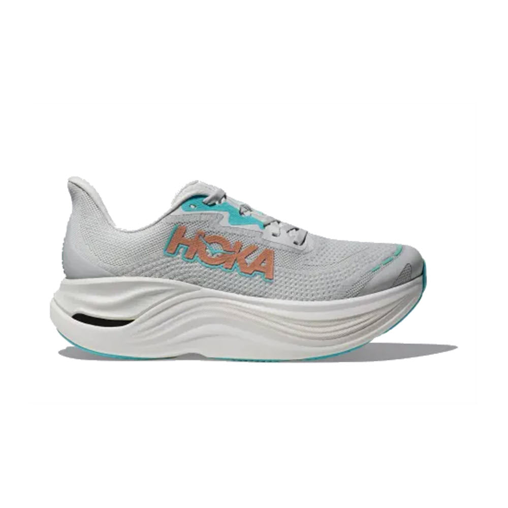 Side view of the HOKA SKYWARD X COSMIC GREY/ROSE - WOMENS by Hoka, a light grey running shoe with aqua and orange accents, thick cushioned sole for plush comfort, and a breathable mesh upper.
