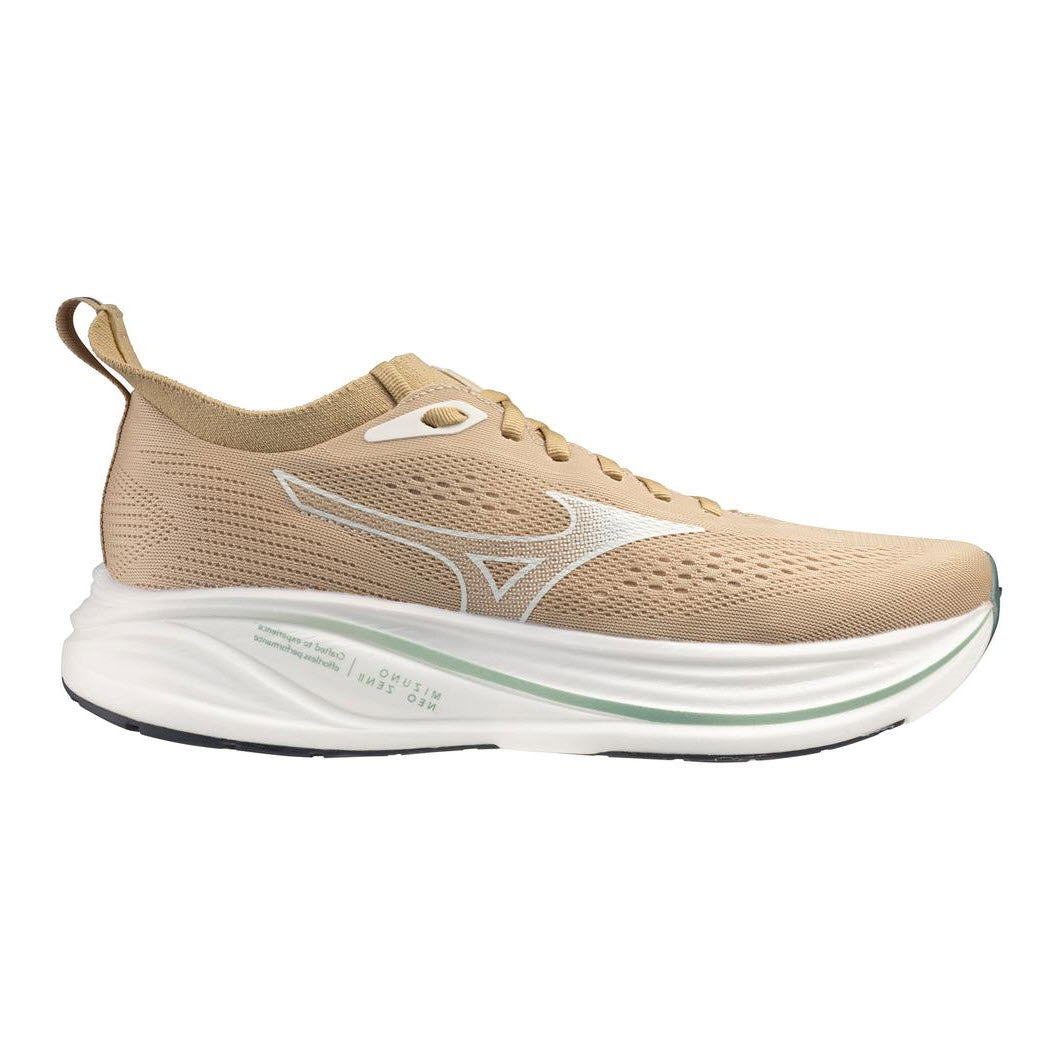 A tan athletic running shoe with a white midsole, subtle green accents, black outsole, and white logo on the side. The shoe has a breathable mesh upper and a pull tab at the heel.