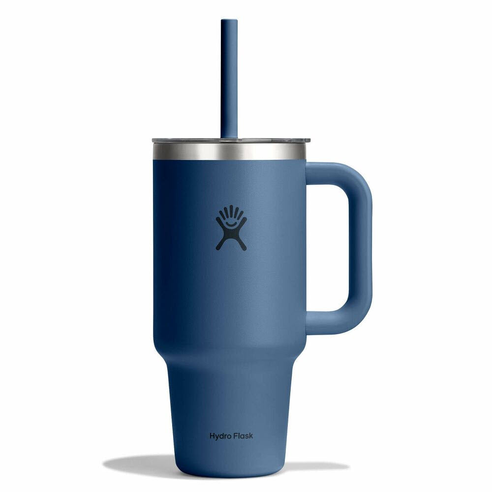 A blue Hydro Flask tumbler with a large handle, a stainless steel rim, a matching blue straw, and the Hydro Flask logo on the front.
