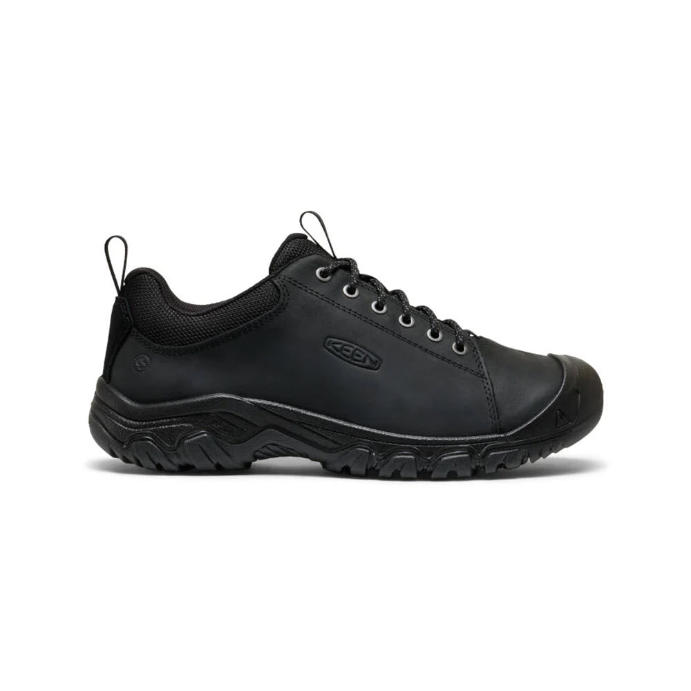 A black, low-cut work shoe with a rugged, slip-resistant sole, lace-up closure, reinforced toe, and pull loops on the heel and tongue. The KEEN logo is visible on the side.