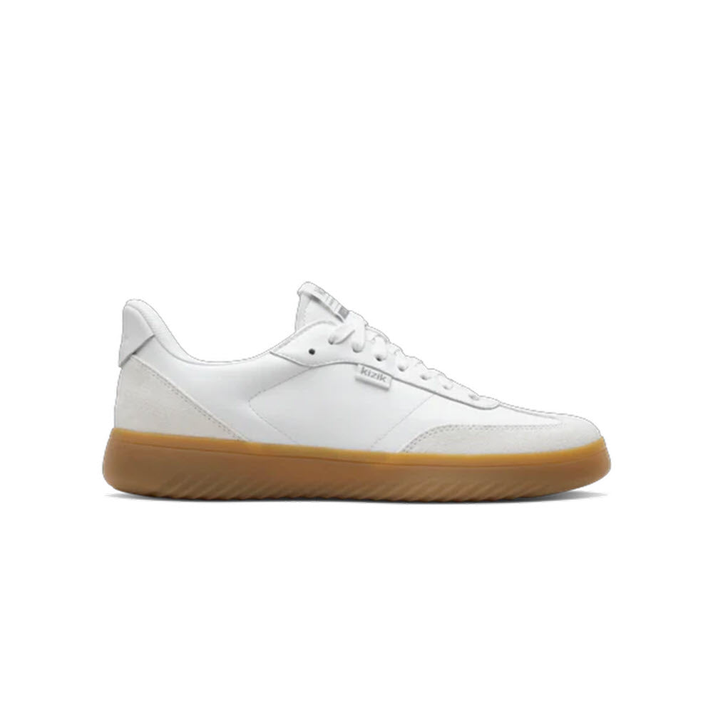 A white low-top sneaker with a lace-up design and a light brown gum sole, shown in a side profile view on a plain white background.