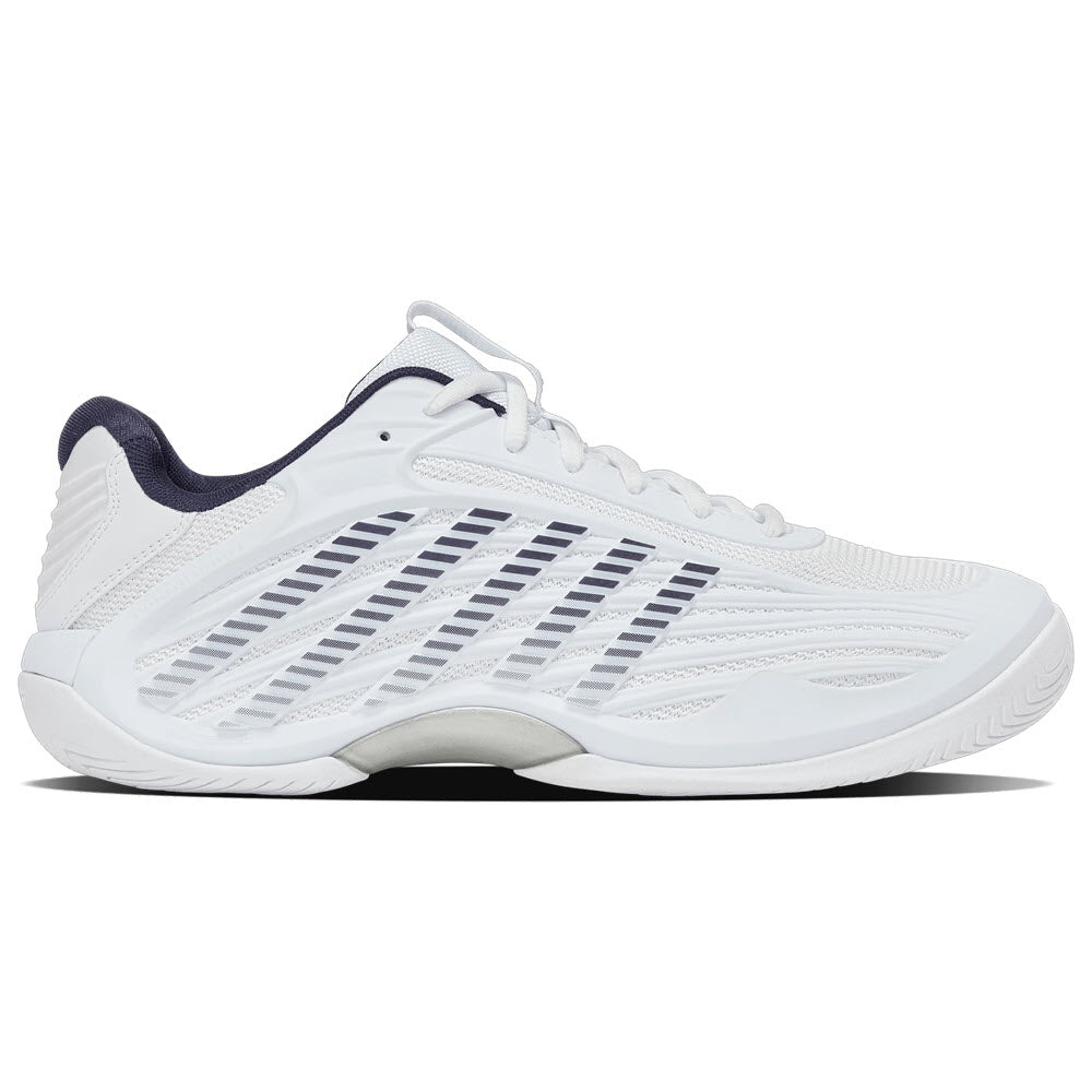 A white athletic sneaker with a low profile, featuring black diagonal lines on the side and a dark-colored inner lining. The sole is white with subtle textured patterns for grip.