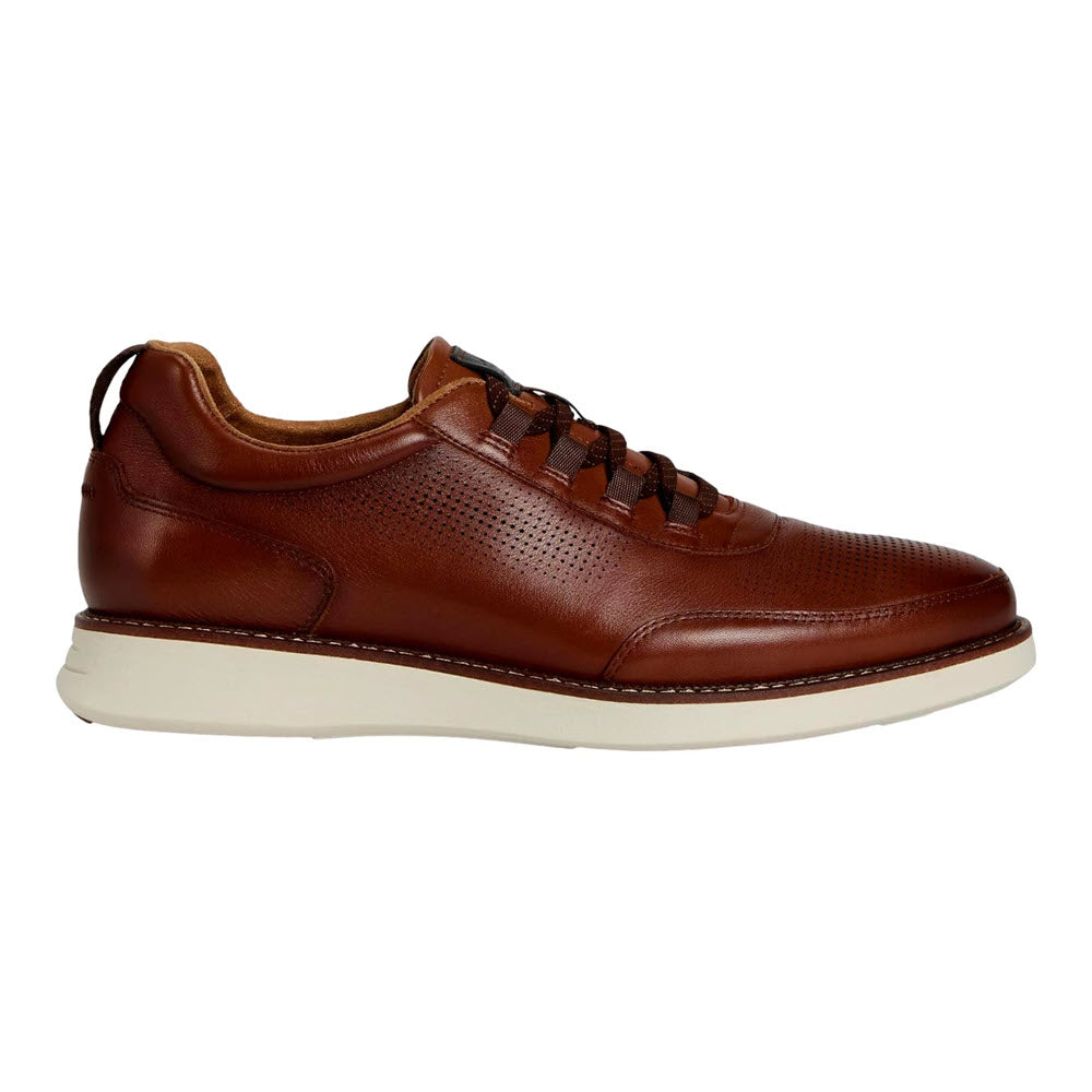 A brown leather sneaker with perforated details, brown laces, a low-top design, and a white rubber sole, shown in a side view against a white background.