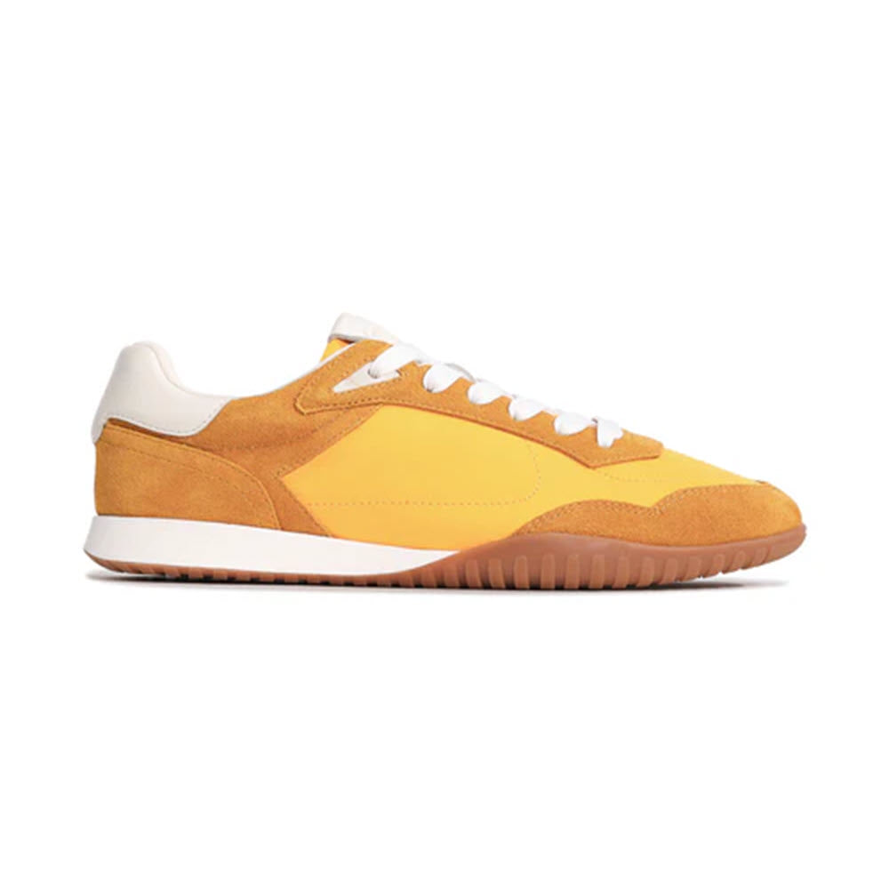 Yellow and brown low-top sneaker with white laces, a white heel tab, and a light brown rubber sole, photographed from the side against a white background.