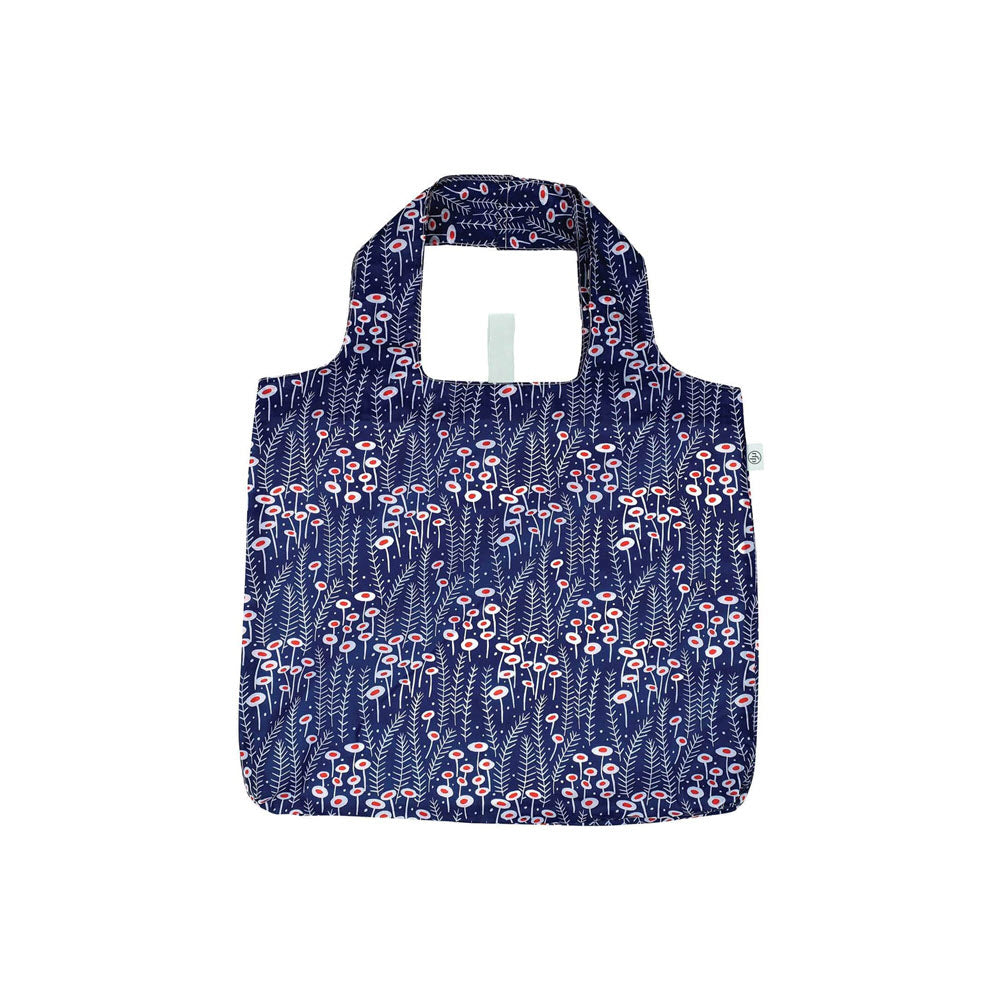 A reusable shopping bag with short handles, featuring a navy blue background and a pink and white floral pattern. The bag is laid flat on a white surface.