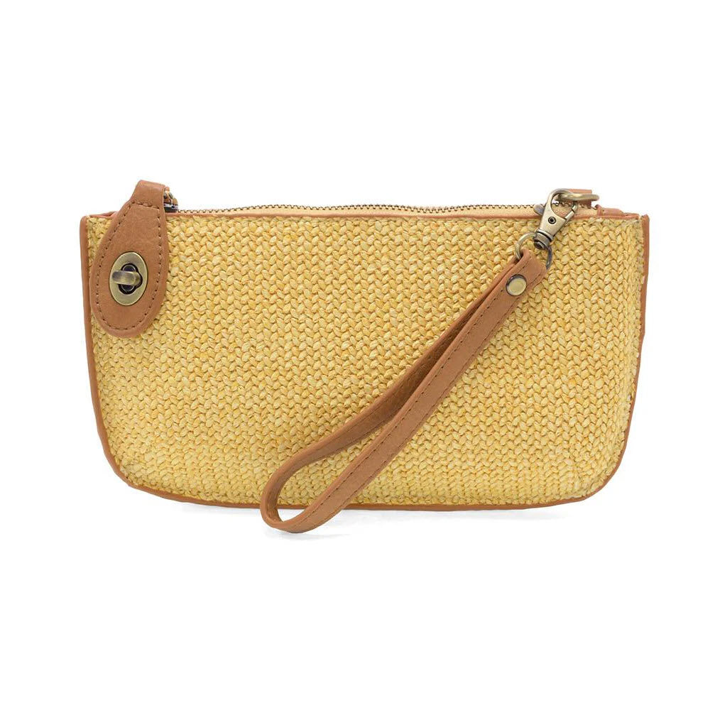 A small woven beige clutch purse with brown leather trim, a wrist strap, and a zippered top. There is a decorative button detail near the zipper on one side.