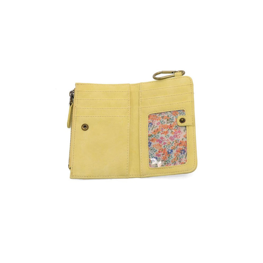A yellow wallet with card slots, a snap button pocket, a clear ID window displaying a floral pattern, and a metal clasp, displayed open on a white background.