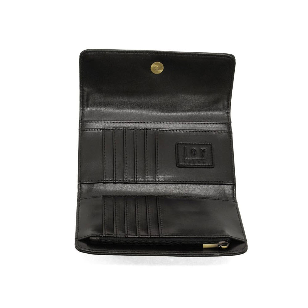 A black leather wallet is open, displaying card slots, a zippered pocket, and a snap button closure on a white background. The word joy is embossed on an inner patch.