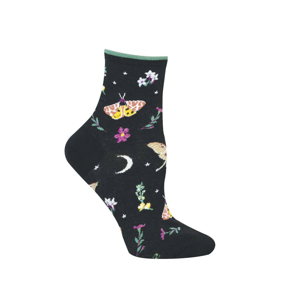 A black sock featuring colorful embroidered designs of moths, flowers, stars, and a crescent moon, shown on a mannequin foot.