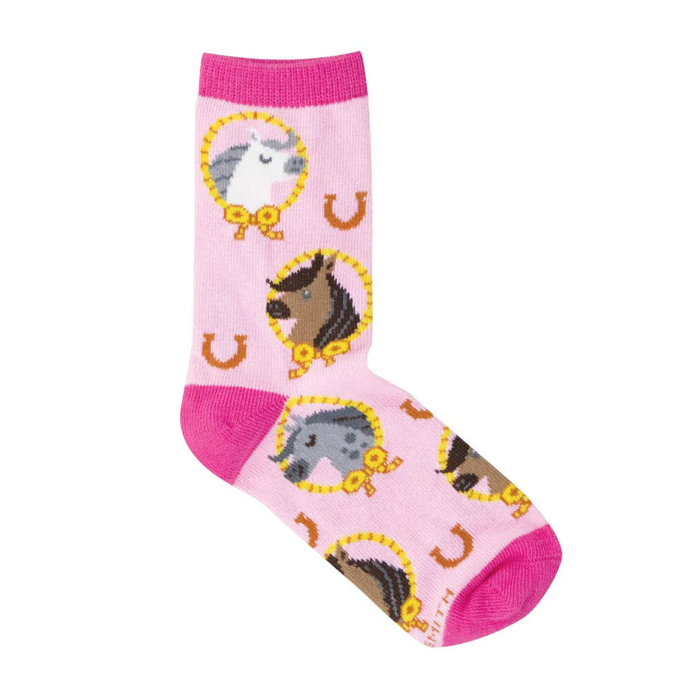 A pink sock with darker pink toe, heel, and cuff, featuring cartoon horse faces in yellow frames and scattered golden horseshoes as a repeating pattern.
