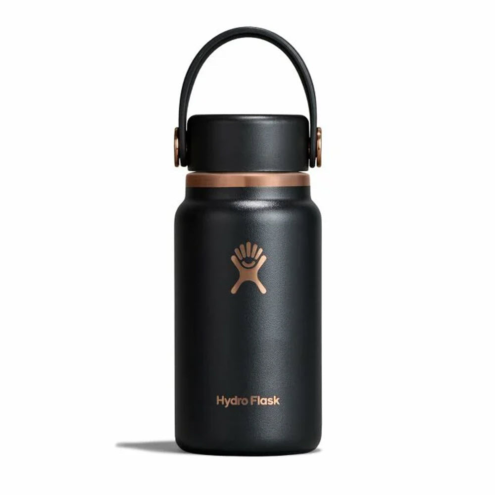 A black Hydro Flask water bottle with a copper-colored cap, handle, and logo, standing upright on a white background.