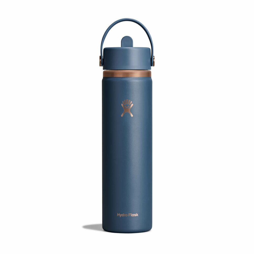 A blue Hydro Flask water bottle with a handle on its lid, featuring a white logo and copper accent near the top, standing upright against a plain white background.