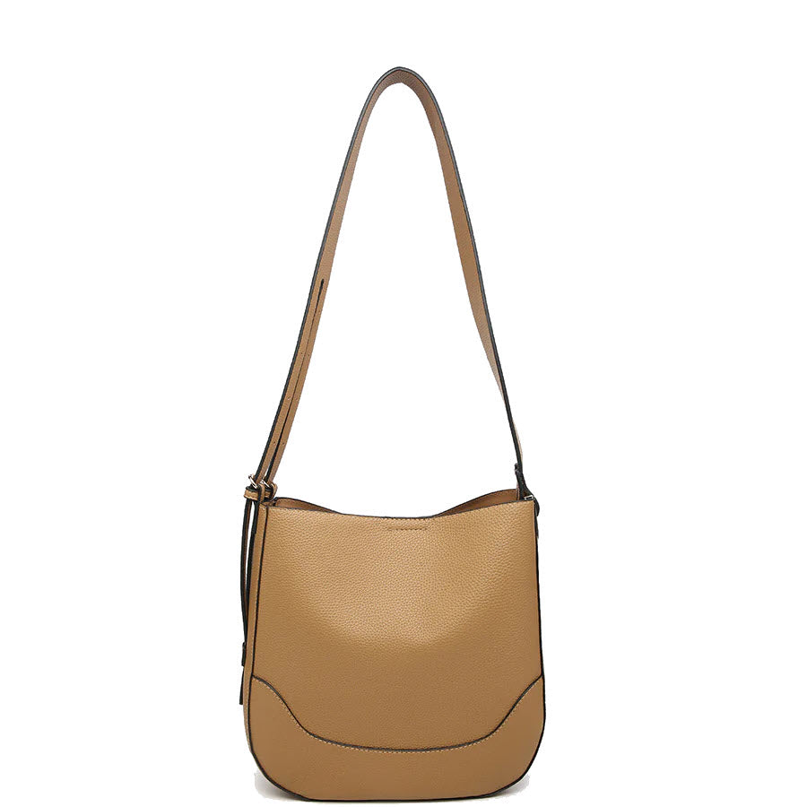 A tan leather shoulder bag with a long strap, rounded bottom edges, and subtle black stitching details. The bag has a minimalist design and a smooth texture.