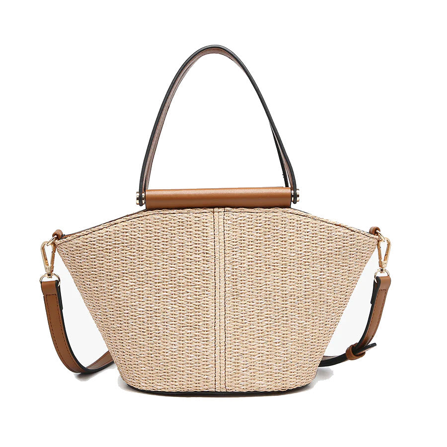 A structured straw handbag with tan leather accents, featuring a top handle, gold hardware, and an adjustable crossbody strap. The bag has a geometric silhouette and a woven texture.
