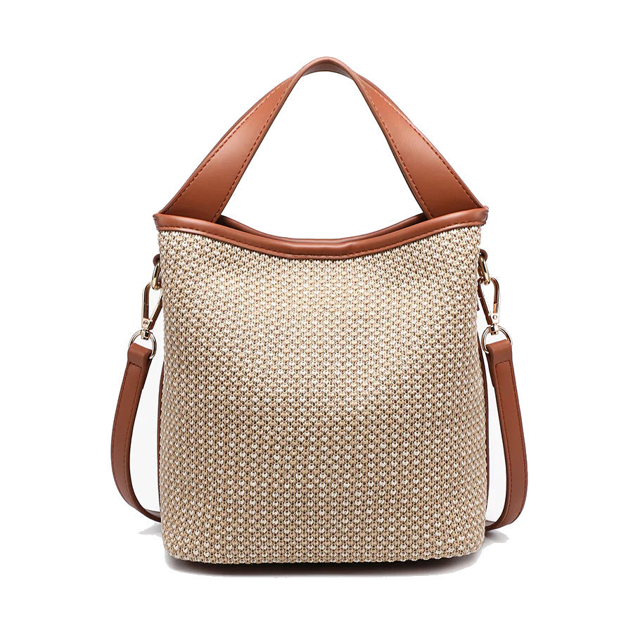 A stylish woven beige tote bag with brown leather handles and a matching adjustable shoulder strap, displayed against a white background.