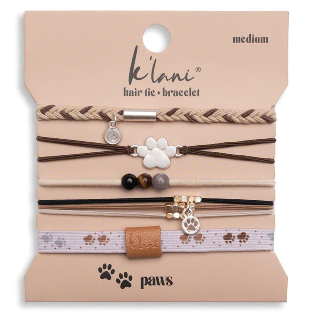 A set of five brown and beige hair ties/bracelets with paw, bead, and charm designs, displayed on a klani branded card labeled medium and paws.