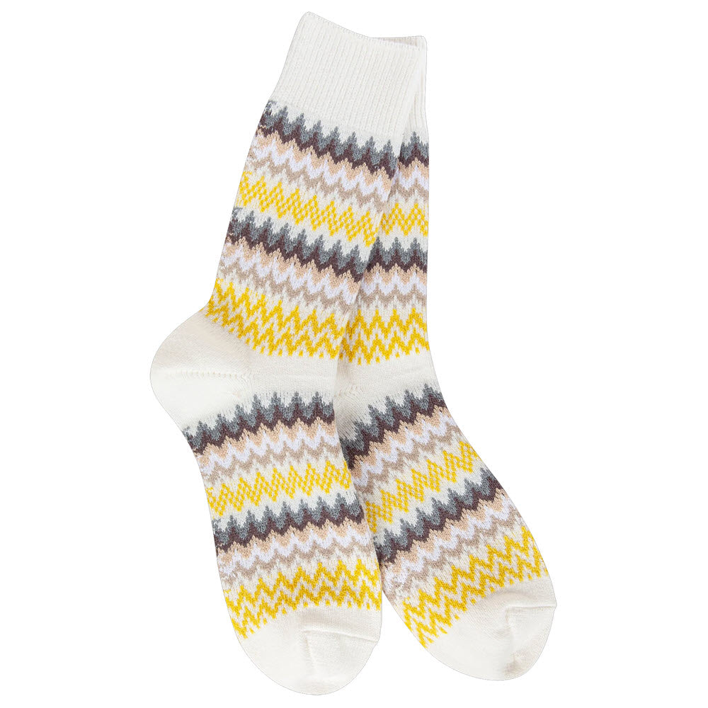 A pair of white crew socks featuring a zigzag pattern in yellow, brown, gray, and beige stripes around the leg and foot. The socks are laid flat side by side.