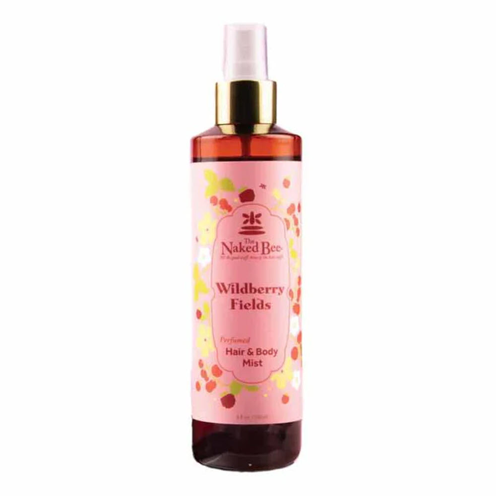 A bottle of The Naked Bee Wildberry Fields Perfumed Hair & Body Mist with a pink label, gold spray top, and floral design, containing 8 fluid ounces.