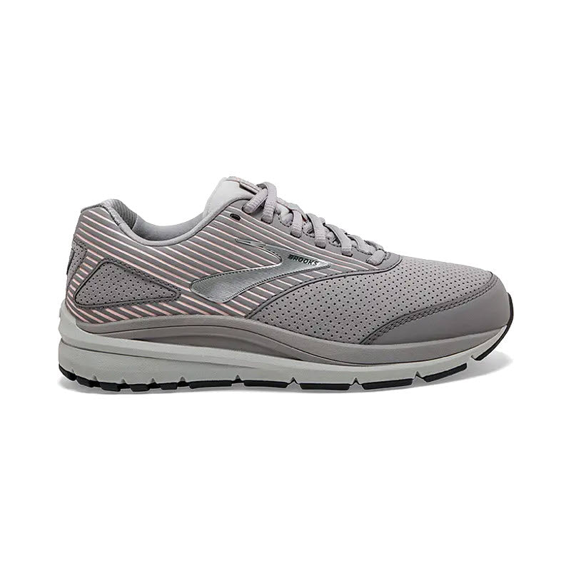 A single gray Brooks Addiction Walker Suede Shark/Alloy women&#39;s walking shoe with a striped design on the side and thick, white rubber sole, displayed on a white background.