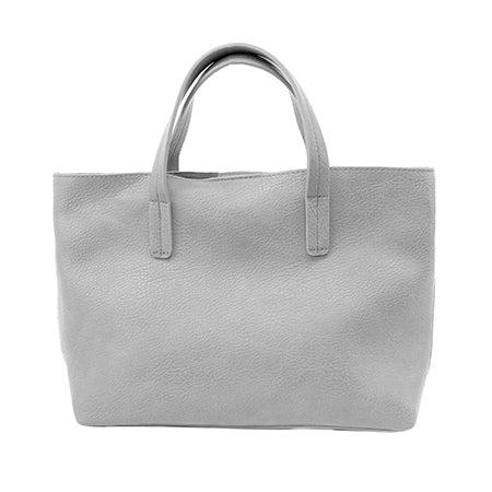 A gray Joy Susan Kelsey Mini Tote bag made of vegan-friendly faux leather isolated on a white background.