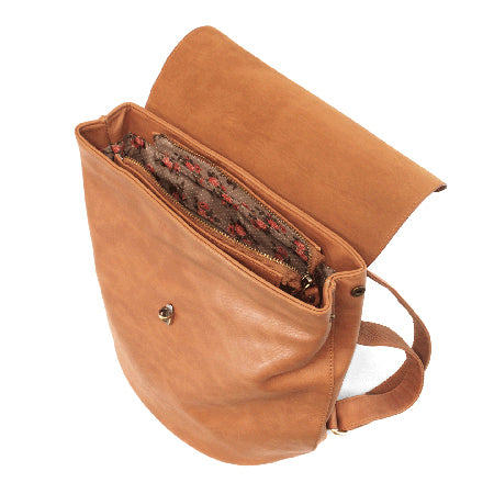 An open brown Joy Susan Colette backpack bourbon with a floral lined interior.
