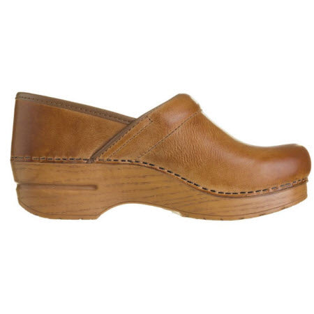Brown full-grain leather Dansko Professional Honey Distressed clog shoe on a white background.