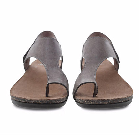 A pair of gray, Dansko Reece Waxy Burnished Stone open-toe leather sandals displayed against a white background.
