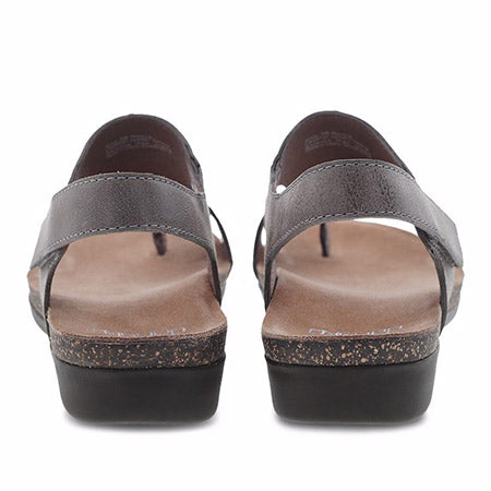 A pair of brown leather women&#39;s sandals with a low heel and a single wide strap over the top, viewed from the front on a white background. - Dansko Reece Waxy Burnished Stone sandals for women.