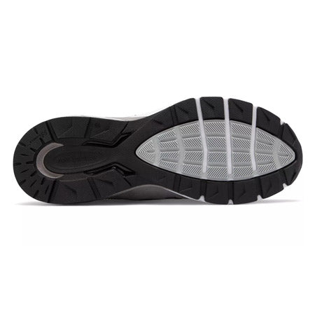 Sole of a modern New Balance 990V5 Grey - Mens running shoe with a black and gray tread pattern.