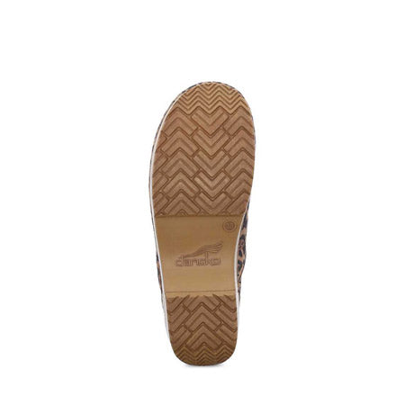 Sole of a Dansko Professional Leopard Suede clog with herringbone pattern tread and brand logo visible.