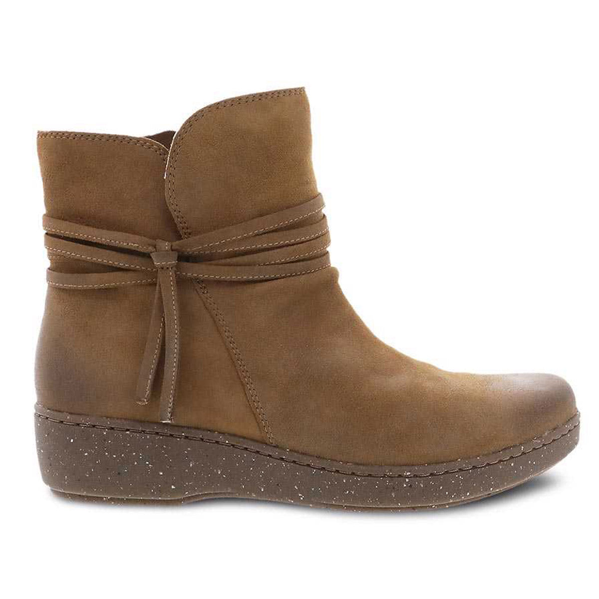 A brown suede Dansko Evelyn Biscotti Burnished Suede bootie with decorative wraparound lacing and studded detail on the sole, featuring 3M Scotchgard protector for durability.