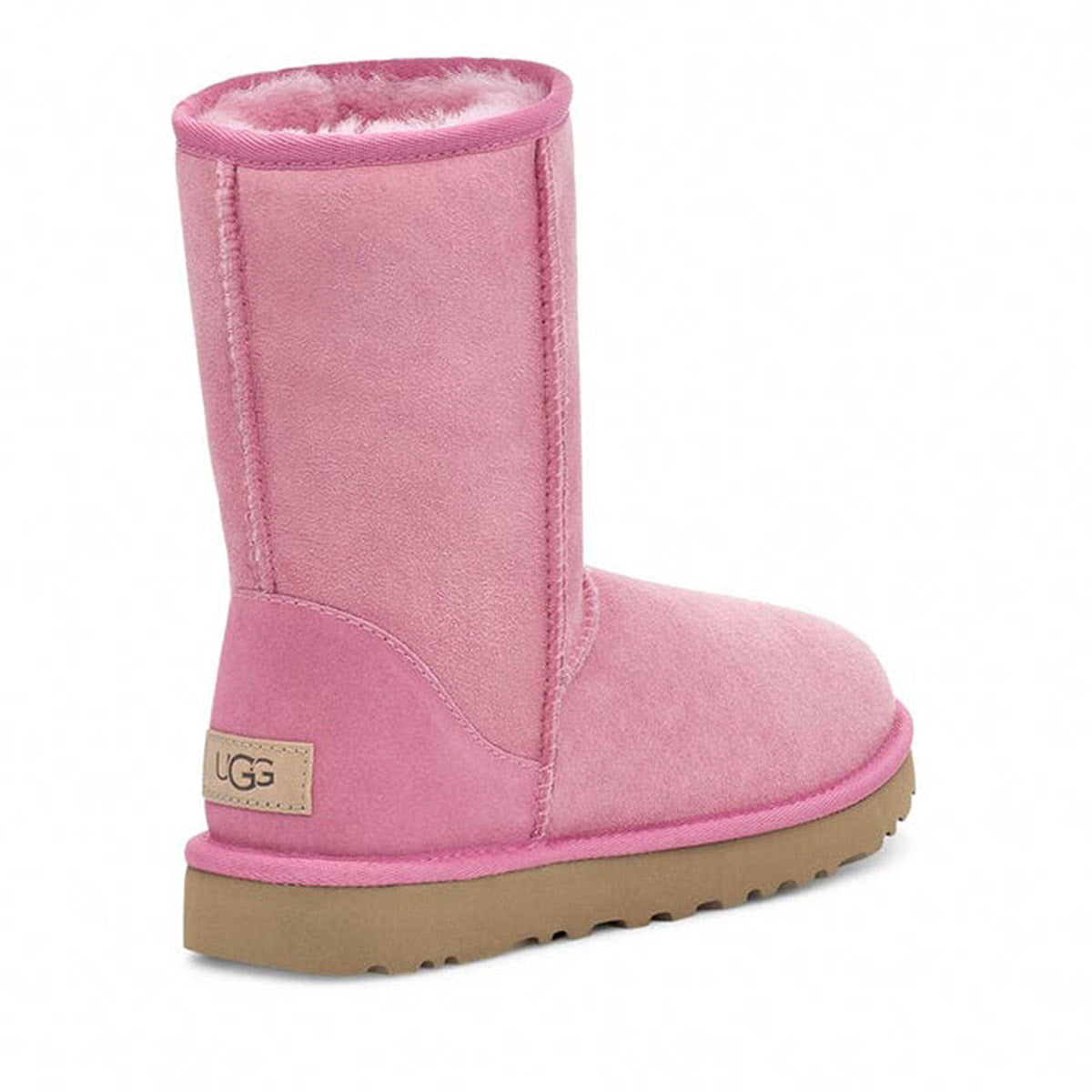 A pink UGG Classic Short II Wild Berry boot with a Twinface sheepskin exterior and a plush interior, featuring a Treadlite by UGG outsole.
