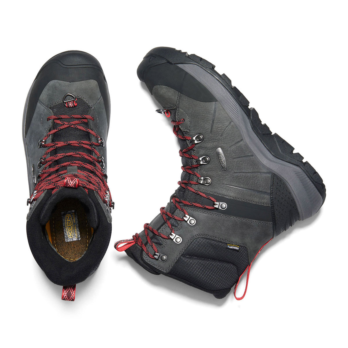 Pair of Keen Revel IV High Polar hiking boots seen from above with one boot inverted showing the interior, including the Thermal Heat Shield insole.