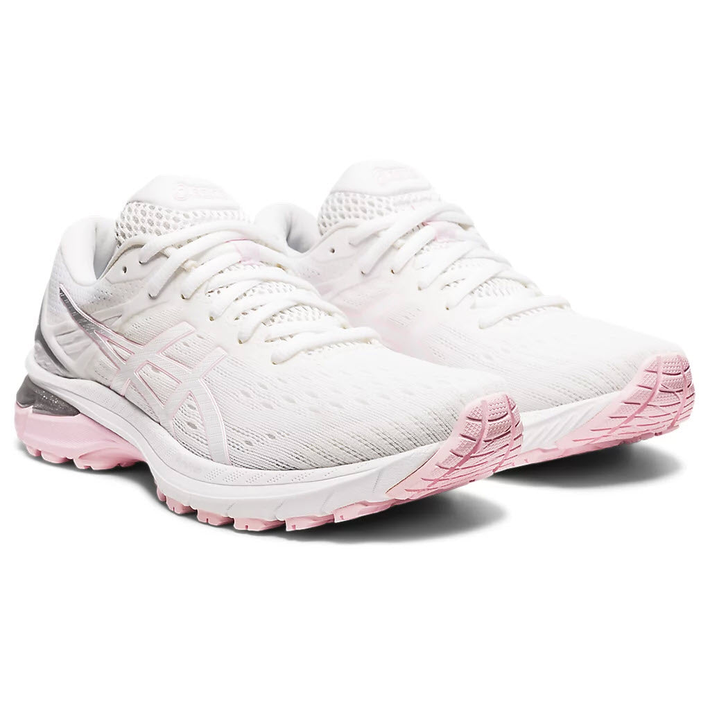 A pair of white Asics GT 2000 v9 women’s running shoes with pink soles.