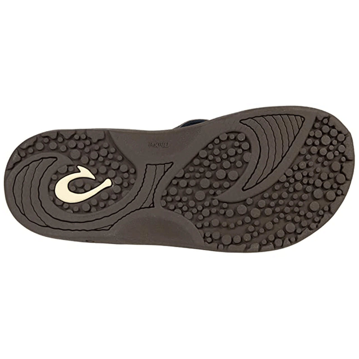 Sole of a men’s sandal with textured patterns and a circular logo. 
Product Name: OLUKAI HOKUA DARK WOOD - MENS 
Brand Name: Olukai