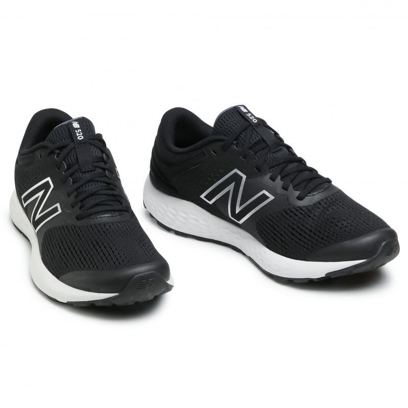 A pair of black New Balance 520v7 men&#39;s running shoes with white soles.